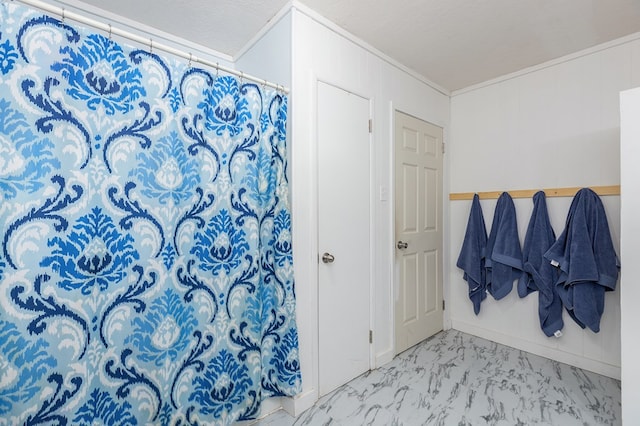 bathroom featuring a textured ceiling and ornamental molding