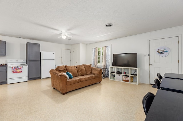 living room featuring a textured ceiling and ceiling fan