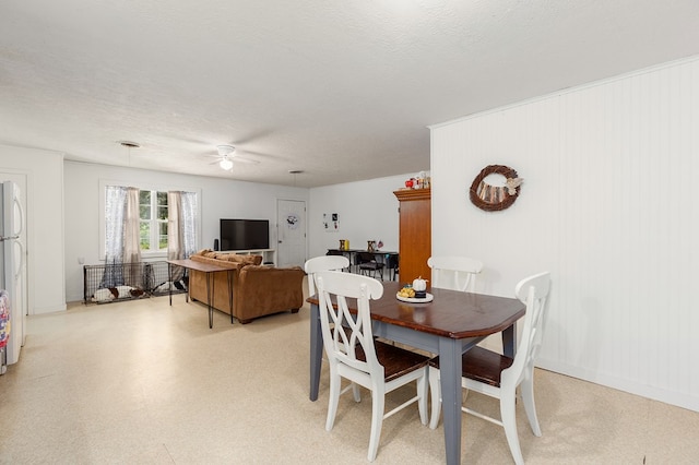 dining room with a textured ceiling and ceiling fan