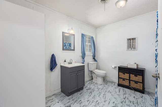 bathroom featuring vanity, toilet, and crown molding