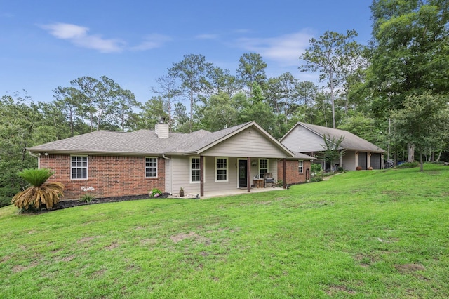 view of front facade with a patio area and a front yard