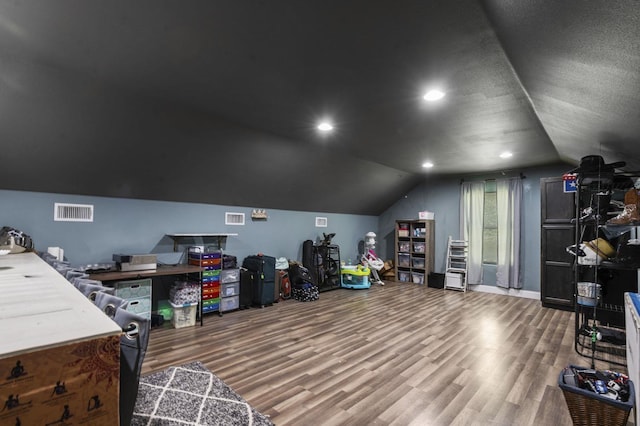 additional living space with lofted ceiling and hardwood / wood-style flooring