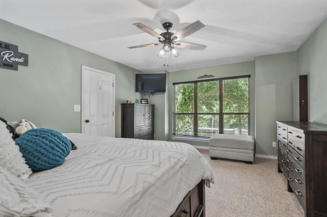 bedroom featuring light colored carpet and ceiling fan