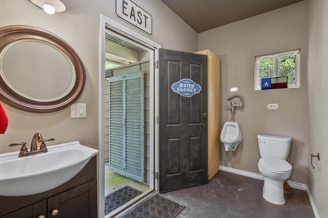 bathroom featuring vanity, concrete flooring, lofted ceiling, and toilet