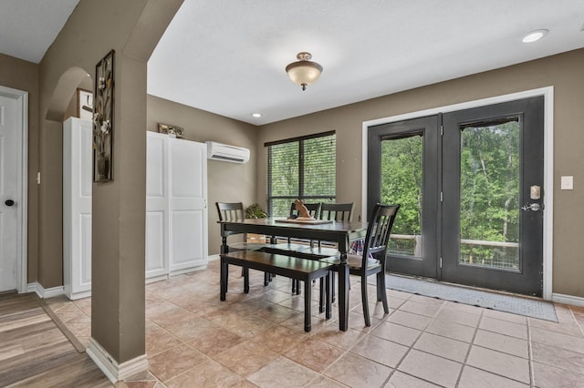 dining space featuring light tile patterned flooring and a wall mounted air conditioner