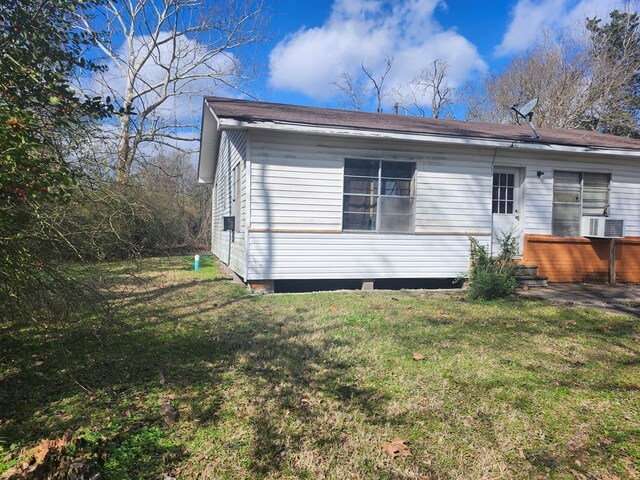 rear view of property with a lawn