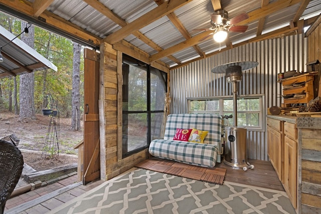 sunroom / solarium with beam ceiling and ceiling fan