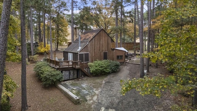 rear view of house featuring a wooden deck