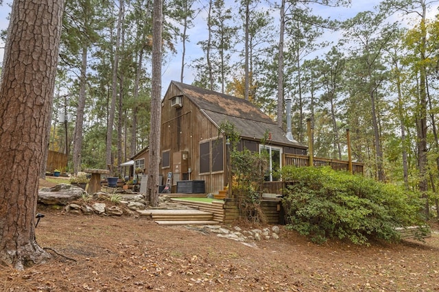 back of property featuring a deck and central AC