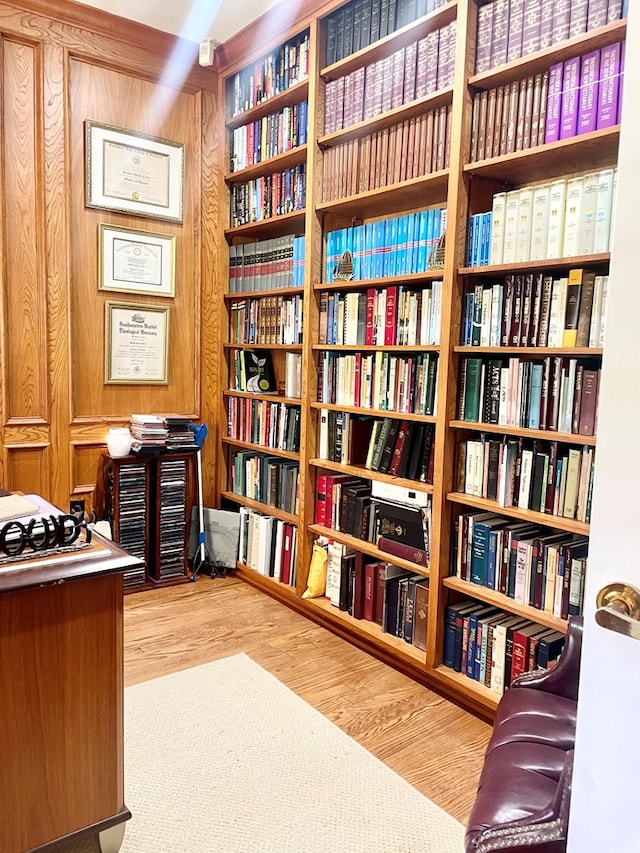 office area featuring hardwood / wood-style flooring and wood walls