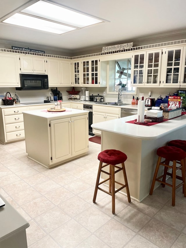 kitchen with dishwasher, a center island, sink, a breakfast bar, and ornamental molding