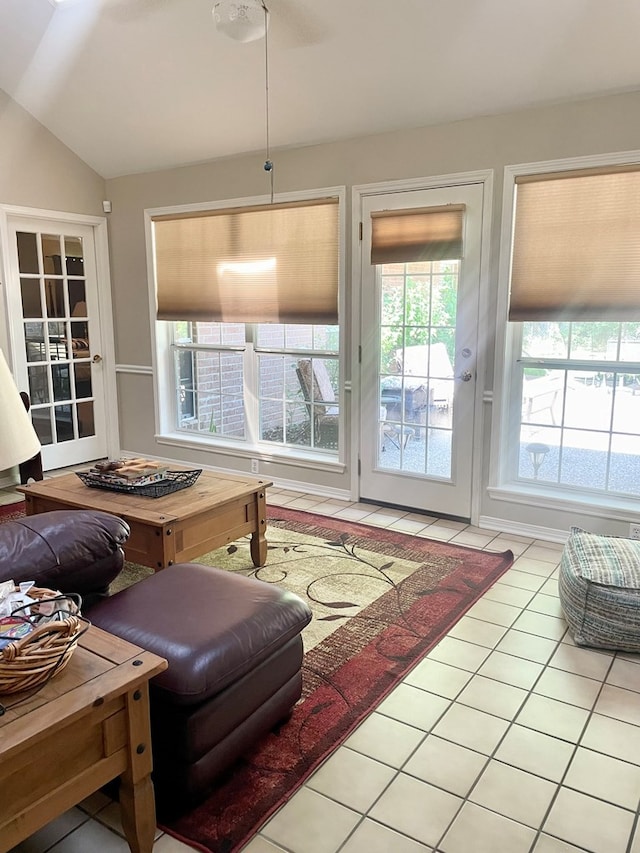 living room featuring tile patterned flooring and lofted ceiling