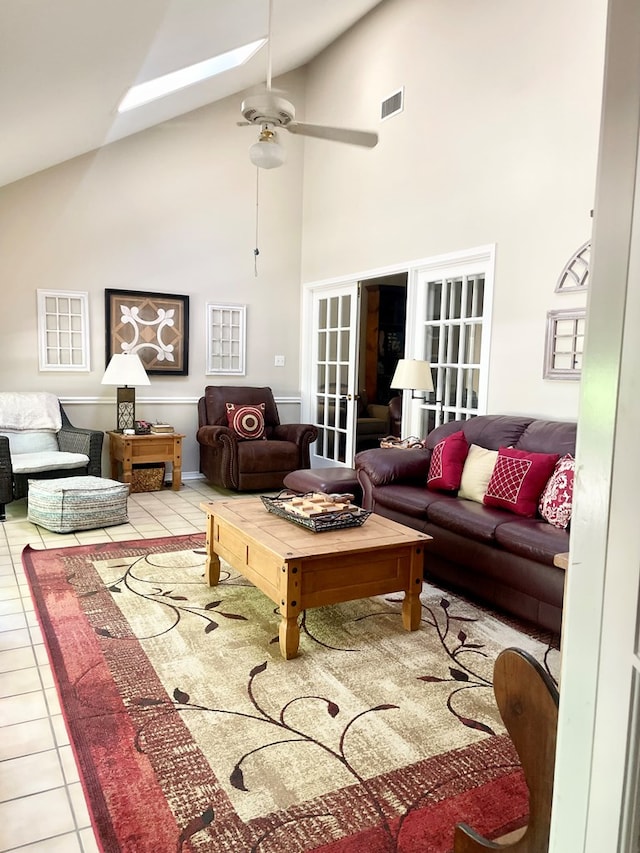 tiled living room with french doors, high vaulted ceiling, and ceiling fan