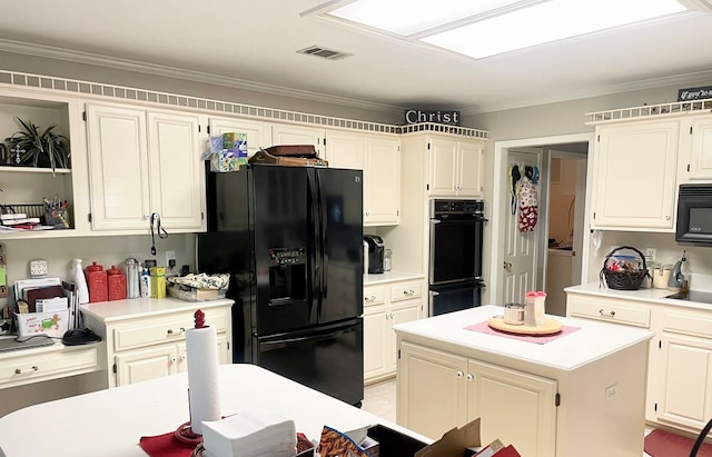 kitchen featuring crown molding, a kitchen island, and black appliances