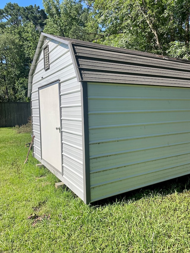 view of outbuilding with a yard