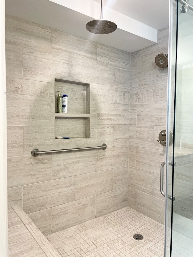 bathroom with a shower with shower door