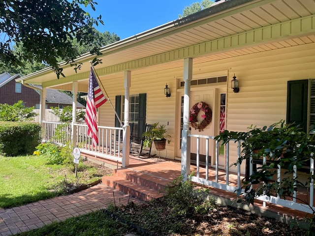 view of exterior entry with a porch