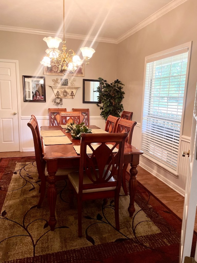 dining room featuring a chandelier, crown molding, and dark wood-type flooring