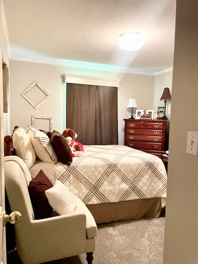 bedroom with ornamental molding and carpet floors