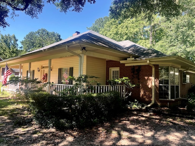 view of property exterior with a porch