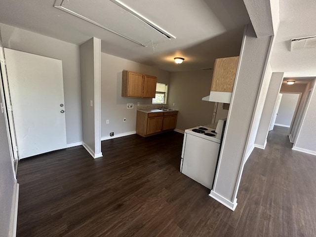 kitchen featuring white range with electric cooktop, dark hardwood / wood-style flooring, and sink