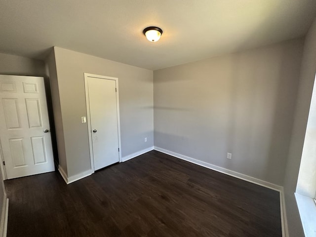 spare room featuring dark wood-type flooring