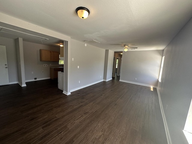 unfurnished living room with ceiling fan and dark hardwood / wood-style flooring