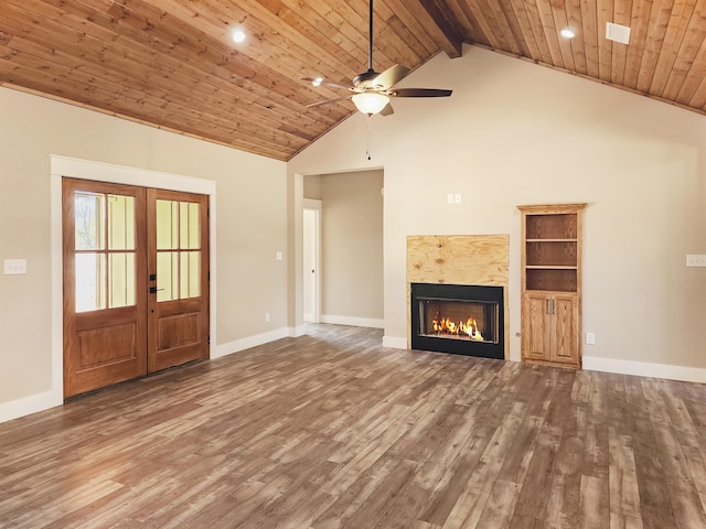 unfurnished living room featuring hardwood / wood-style floors, beamed ceiling, wooden ceiling, and french doors