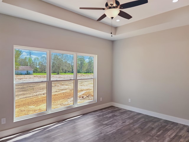 empty room with dark hardwood / wood-style floors and ceiling fan