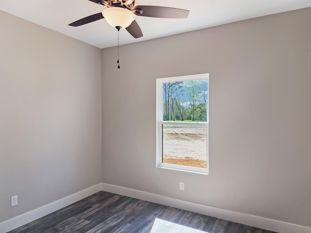 empty room with ceiling fan and dark hardwood / wood-style floors