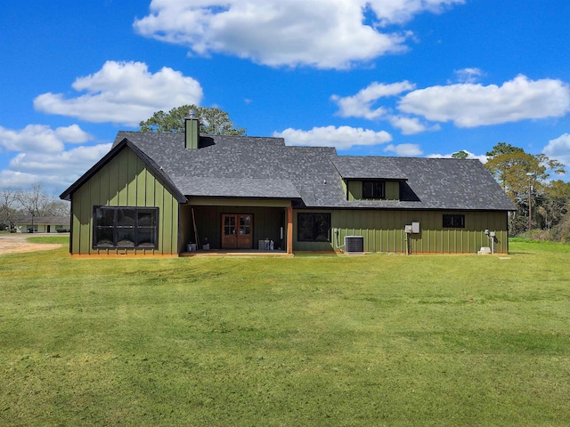 exterior space featuring central air condition unit and a lawn