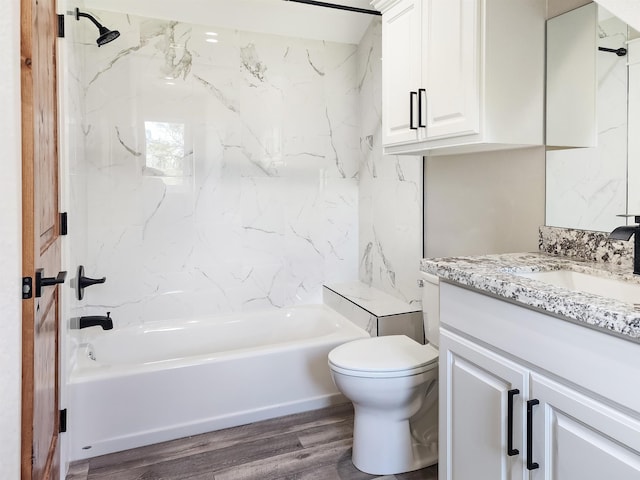 full bathroom with hardwood / wood-style floors, vanity, toilet, and tiled shower / bath combo