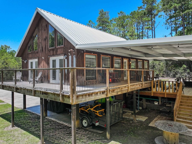 back of property with a wooden deck and french doors