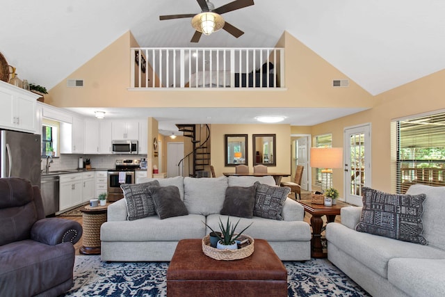 living room featuring high vaulted ceiling and ceiling fan