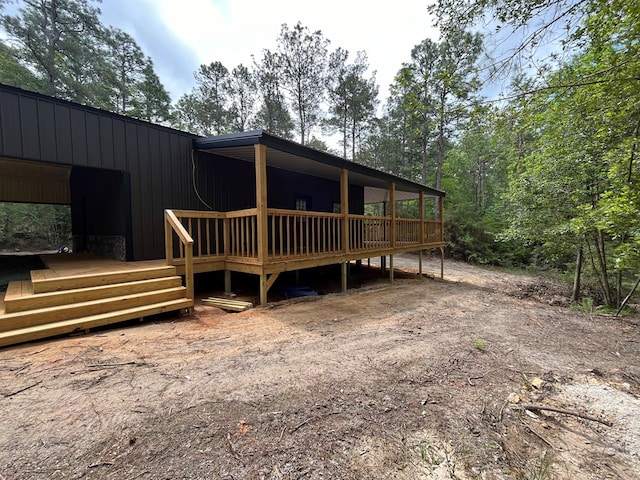 rear view of property featuring a wooden deck