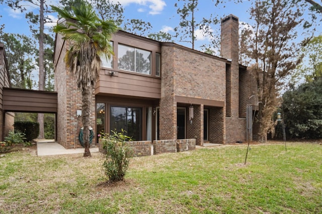 rear view of property featuring a yard