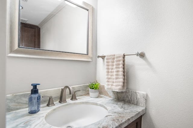 bathroom with vanity and ornamental molding