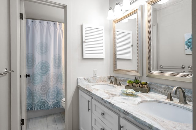 bathroom featuring vanity, a shower with shower curtain, and toilet