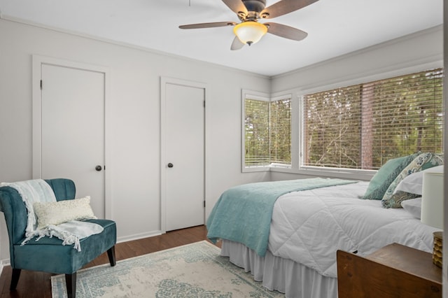 bedroom with hardwood / wood-style floors, ceiling fan, and crown molding