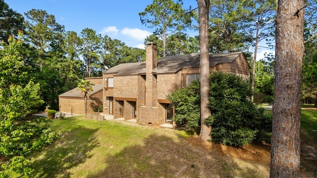 back of property featuring a lawn