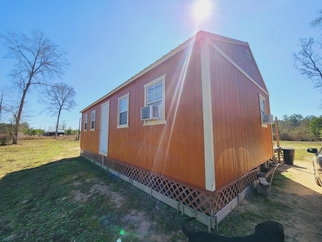 view of home's exterior with a lawn and cooling unit