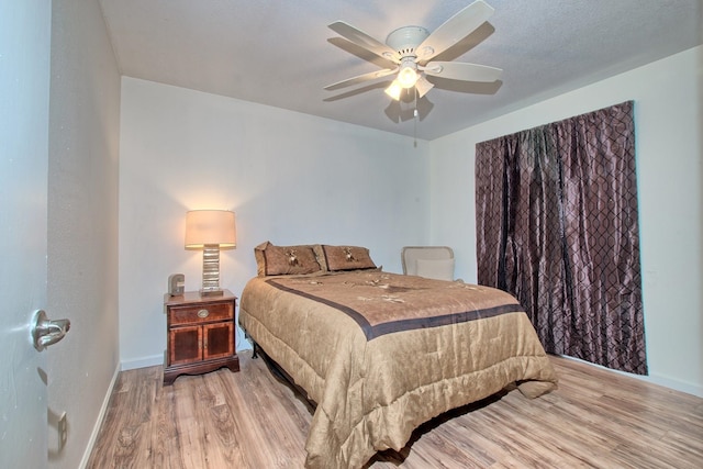 bedroom featuring ceiling fan and wood-type flooring