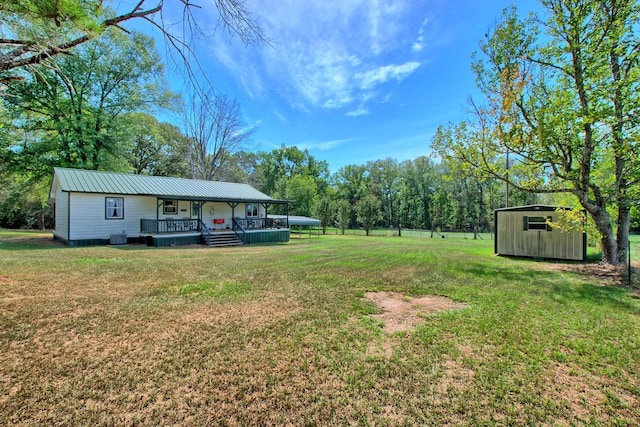 view of yard with a deck and a storage unit