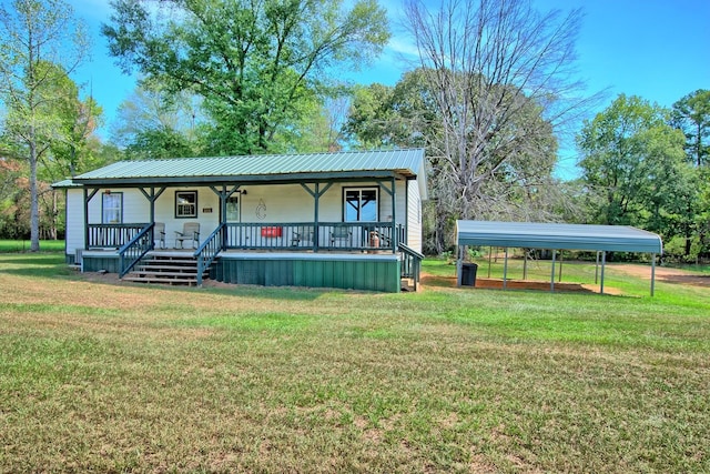 view of front of home with covered porch, a front yard, and a carport