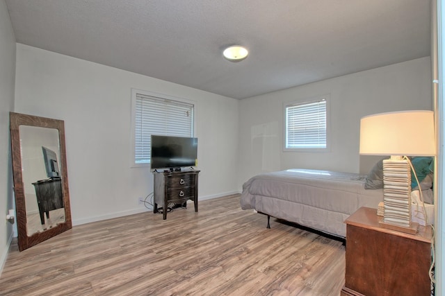 bedroom featuring wood-type flooring and a textured ceiling