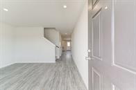 101 Pine Br, Lufkin, TX 75901 - interior space featuring a barn door, light wood finished floors, and baseboards