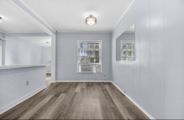 210 Forest Park Blvd, Lufkin, TX 75904 - unfurnished dining area featuring wood finished floors, cooling unit, and ornamental molding