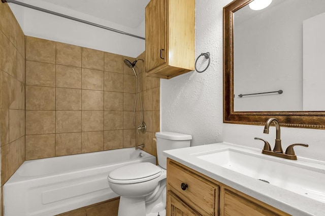 full bathroom featuring vanity, toilet, and tiled shower / bath combo