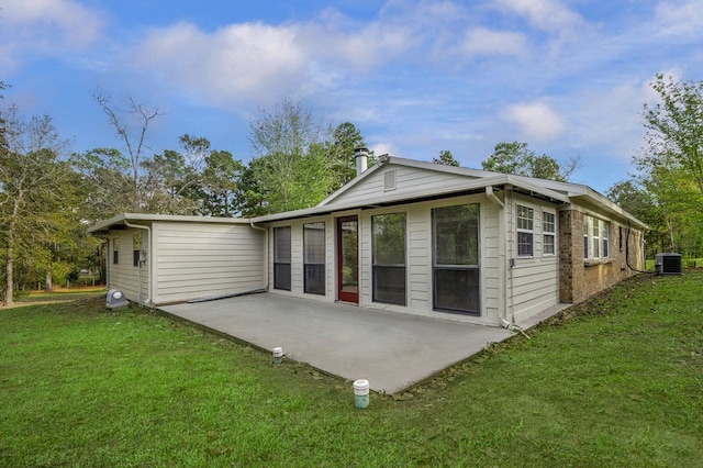 rear view of house featuring a patio, a yard, and central air condition unit