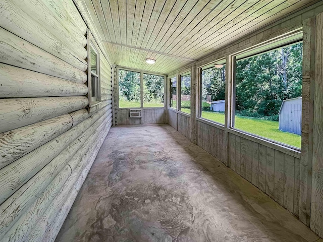 unfurnished sunroom with wood ceiling